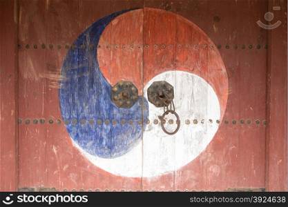 Sam Saeg-ui Taegeuk. Sam Saeg-ui Taegeuk on an old wooden door