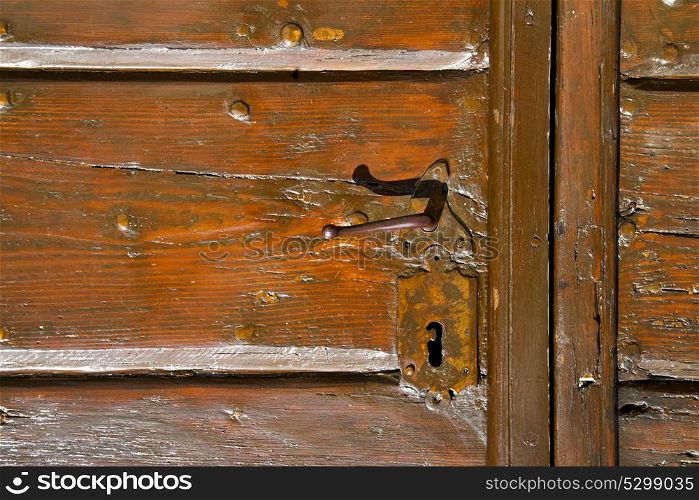 samarate abstract rusty brass brown knocker in a door curch closed wood lombardy italy varese