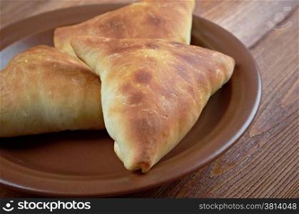 Samosa - Baked stuffed pastry.local cuisines of South Asia, Southeast Asia, Central Asia and Southwest Asia, the Arabian Peninsula, the Mediterranean, the Horn of Africa and North Africa.