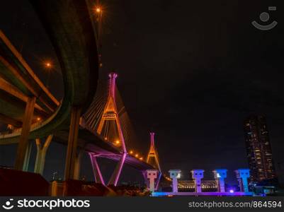 Samutprakan, thailand - jun, 2019 : Bhumibol Bridge also casually call as Industrial Ring Road Bridge with floodgate illuminate with spotlight at night scene, Samut Prakarn, Thailand