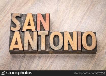 San Antonio word abstract in vintage letterpress wood type against grained wooden background