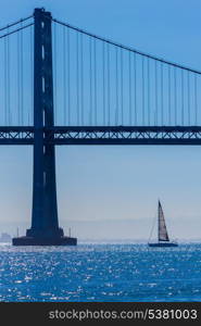 San Francisco Bay bridge sailboat from Pier 7 in California USA