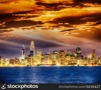 San Francisco city skyline with sea reflections at night. San Francisco city skyline with sea reflections at night.