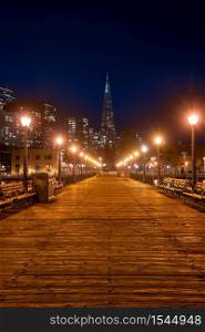 San Francisco downtown cityscape skylines and skyscrapers building from pier at night in California, USA. San Francisco United States Landmark Travel Destination cityscape urban and tourism concept.