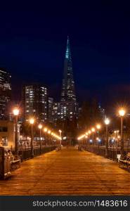 San Francisco downtown cityscape skylines ans skyscrapers building from pier at night in California, USA. San Francisco United States Landmark Travel Destination cityscape urban and tourism concept.