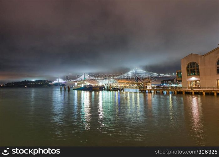 San Francisco Embarcadero and Bay Bridge at night, California, USA.
