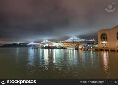 San Francisco Embarcadero and Bay Bridge at night, California, USA.
