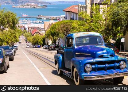 San Francisco Hyde Street and vintage car with Alcatraz California USA
