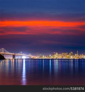 San Francisco sunset skyline and Bay Bridge in California with reflection in bay water USA