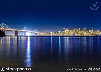 San Francisco sunset skyline and Bay Bridge in California with reflection in bay water USA