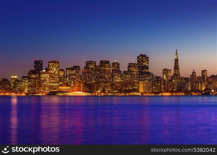 San Francisco sunset skyline in California with reflection in bay water USA