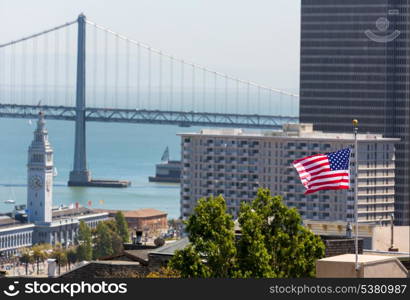 San Francisco USA American Flag Bay Bridge and Embarcadero Clock Tower from Telegraph Hill