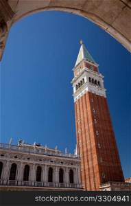 San Marco bell tower rises above an arch in Venice