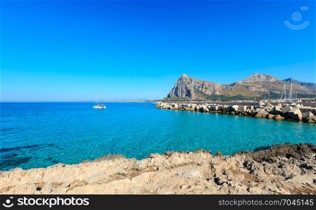 San Vito lo Capo beach with clear azure water and Monte Monaco in far, north-western Sicily, Italy.