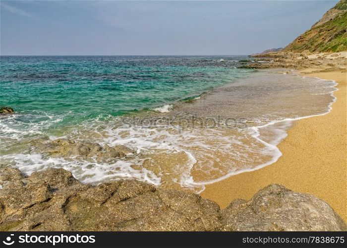 Sand and rocks on Losari beach in the Balagne region of Corsica