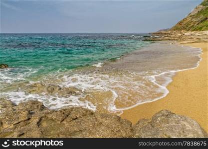 Sand and rocks on Losari beach in the Balagne region of Corsica