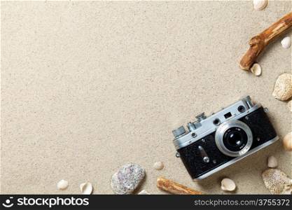 Sand background. Sandy beach texture. Summer concept with old retro camera. Top view