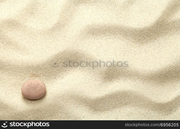 Sand background with stone. Beach texture. Copy space. Top view. Sand Background with Stone