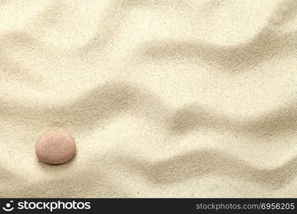 Sand background with stone. Beach texture. Copy space. Top view. Sand Background with Stone