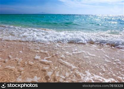 Sand beach and blue sea surf waves close up. Sand beach and sea waves