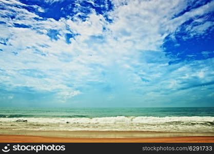 sand beach, ocean and cloudy sky. hdr