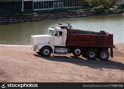 sand gravel truck hauling load from lake