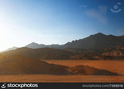 Sand mountains in the desert by day