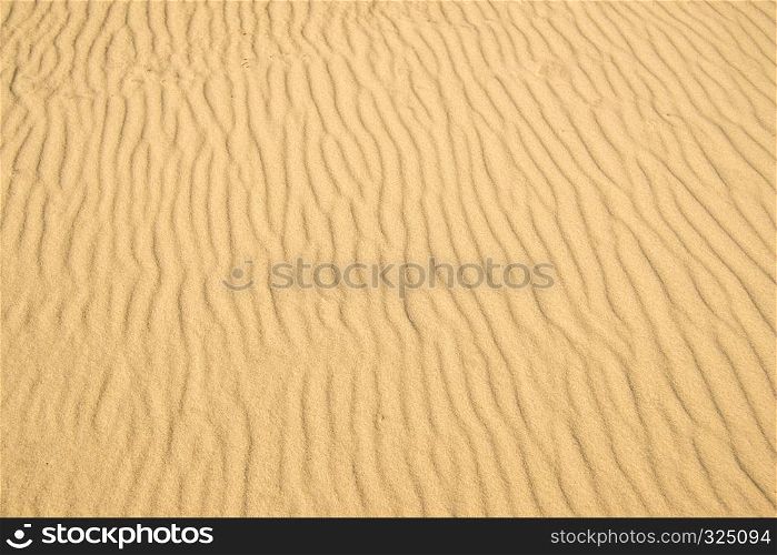 Sand of a beach with wave patterns