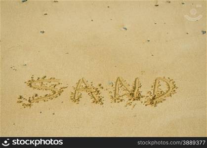sand written in sand on a beach