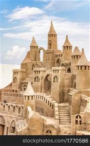 Sandcastle during a sunny day with blue sky background. Concept for summer, vacation, relax and fun.