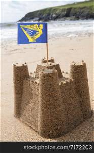 Sandcastle On Beach Flying Irish Flag