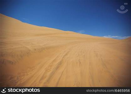 Sands dunes in the desert and blue sky.