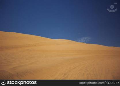 Sands dunes in the desert and blue sky.