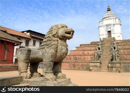 Sandstone lion and temple in Bhaktapur in Nepal