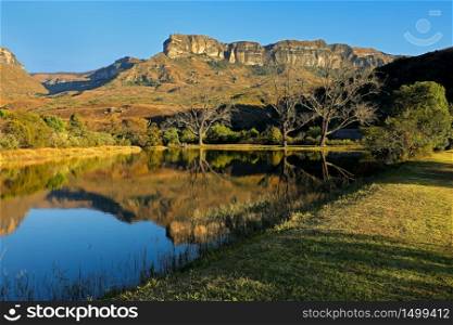 Sandstone mountains and pond with reflection in water, Royal Natal National Park, South Africa