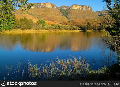 Sandstone mountains and pond with reflection in water, Royal Natal National Park, South Africa