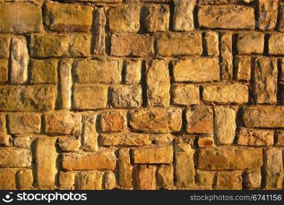 Sandstone yellow brown house wall as background