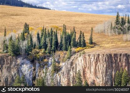 sandtsone cliff and aspen grove in fall colors - overlook of Deep Creek Canyon near Dotsero in Rocky Mountains, Colorado