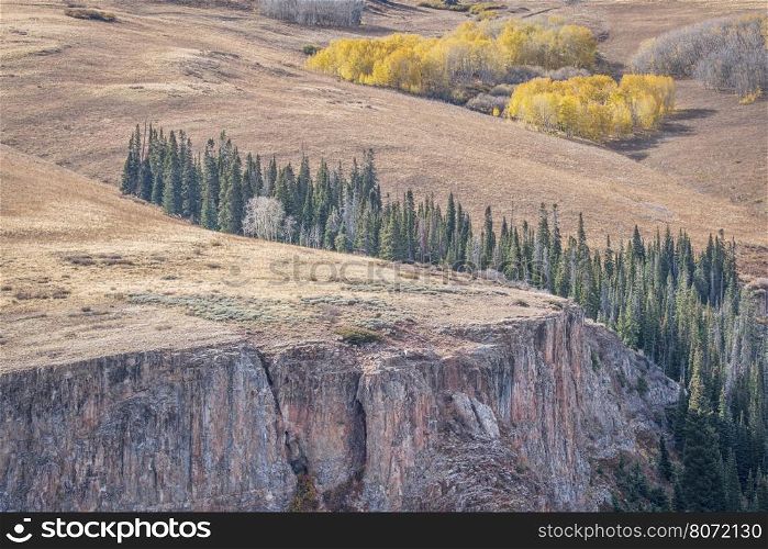 sandtsone cliff and aspen grove in fall colors - overlook of Deep Creek Canyon near Dotsero in Rocky Mountains, Colorado
