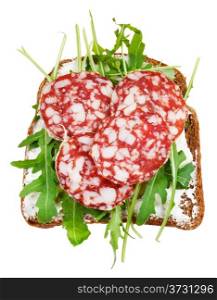 sandwich from rye bread, cottage cheese, salami and rocket salad isolated on white background