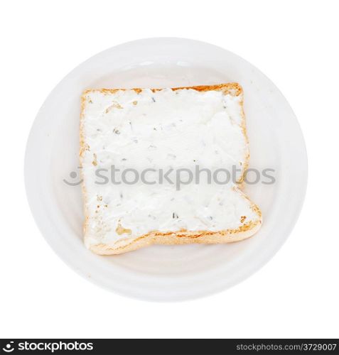 sandwich from toast and soft cheese with herbs on white plate isolated on white background