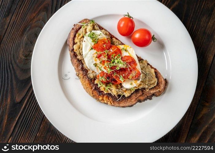 Sandwich with baked eggplant, tomatoes and mozzarella