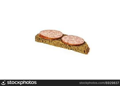 Sandwich with black bread and sausage on a white background