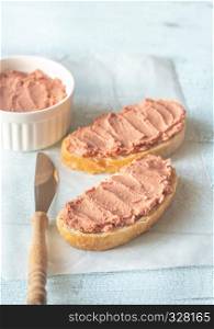 Sandwich with chicken liver pate on the white baking paper