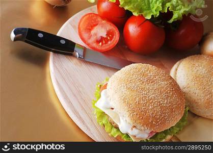 sandwich with cutlet and vegetables lies on plate