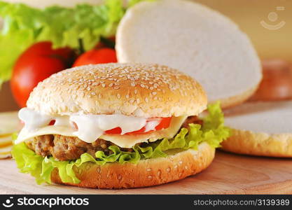 sandwich with cutlet and vegetables lies on plate