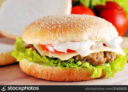 sandwich with cutlet and vegetables lies on plate