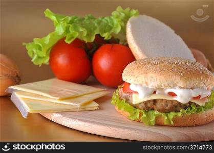 sandwich with cutlet and vegetables lies on plate