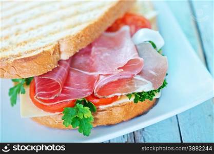 sandwich with ham and vegetables on the plate