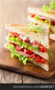 sandwich with ham tomato and lettuce